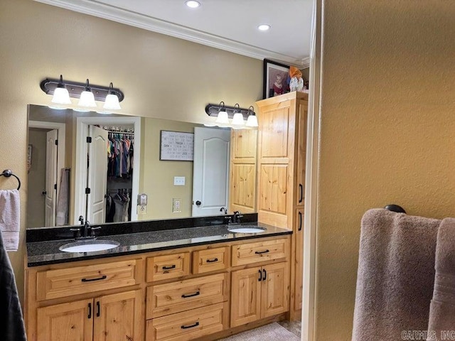 bathroom with ornamental molding and vanity