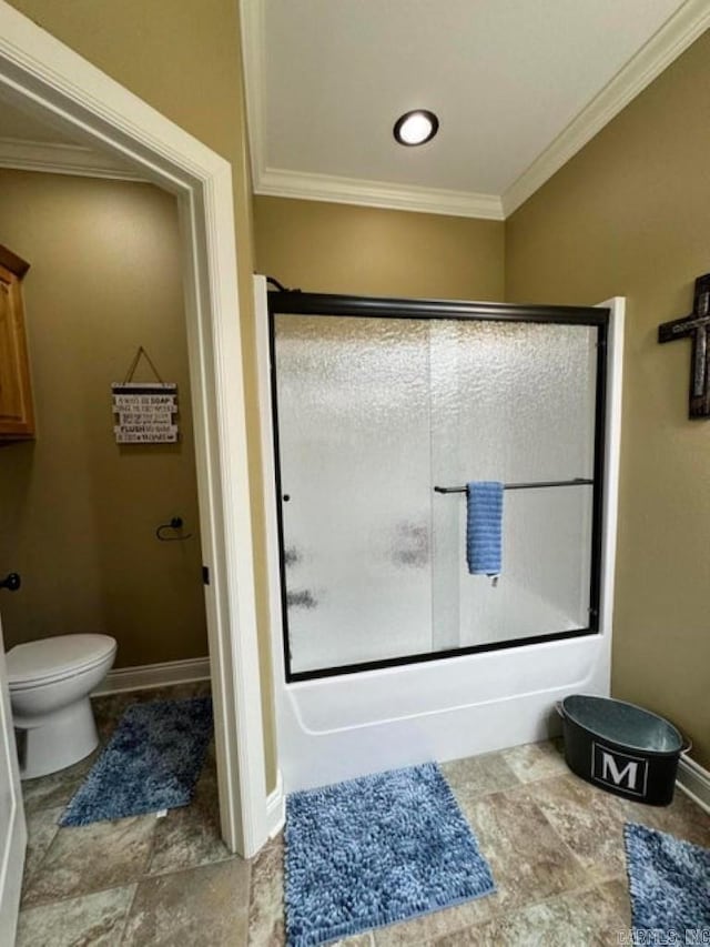 bathroom featuring ornamental molding, combined bath / shower with glass door, and toilet