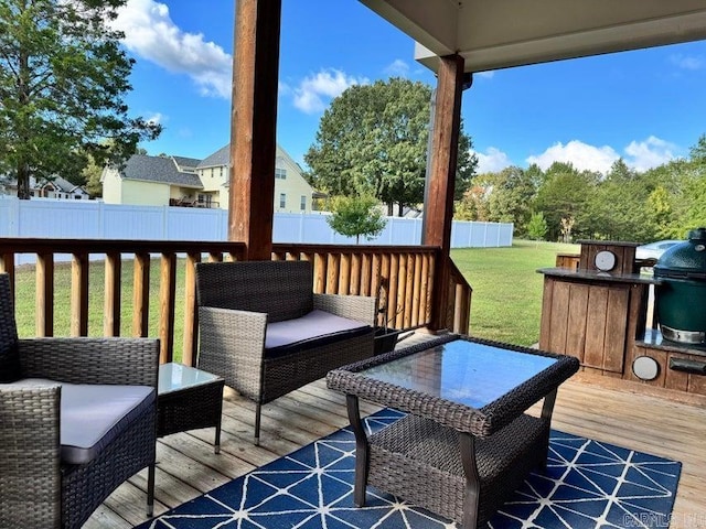 wooden terrace featuring a grill and a lawn