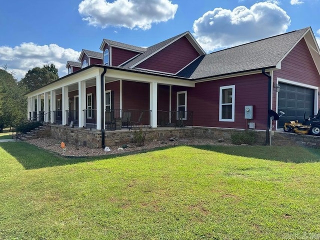 exterior space featuring a porch, a garage, and a front yard