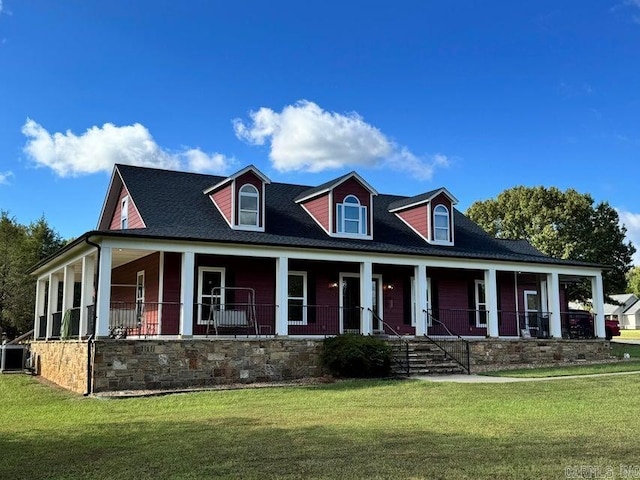 cape cod house with a front yard and covered porch