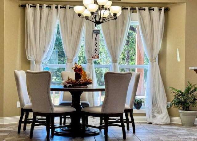 tiled dining room featuring an inviting chandelier