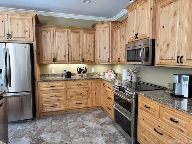 kitchen featuring ornamental molding, stainless steel appliances, dark stone countertops, and light brown cabinetry