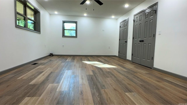 empty room with ceiling fan and dark hardwood / wood-style floors