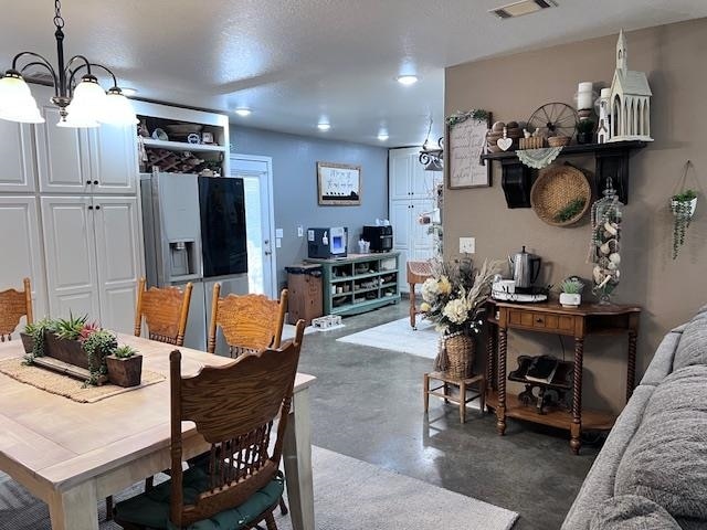 dining space with a notable chandelier