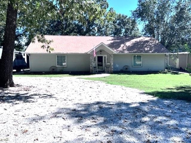 ranch-style home with a front lawn