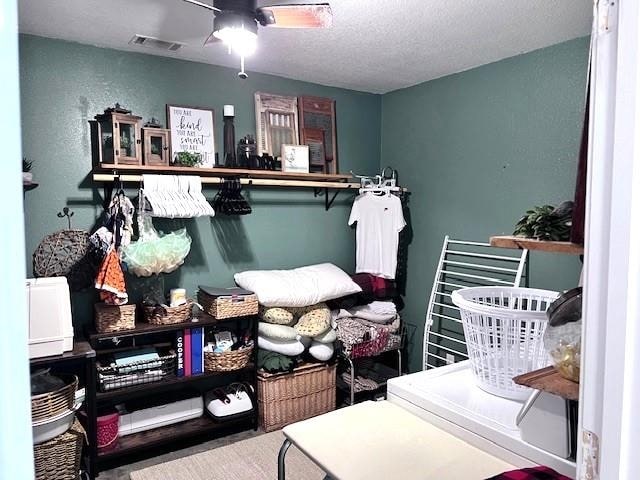 interior space featuring ceiling fan and a textured ceiling