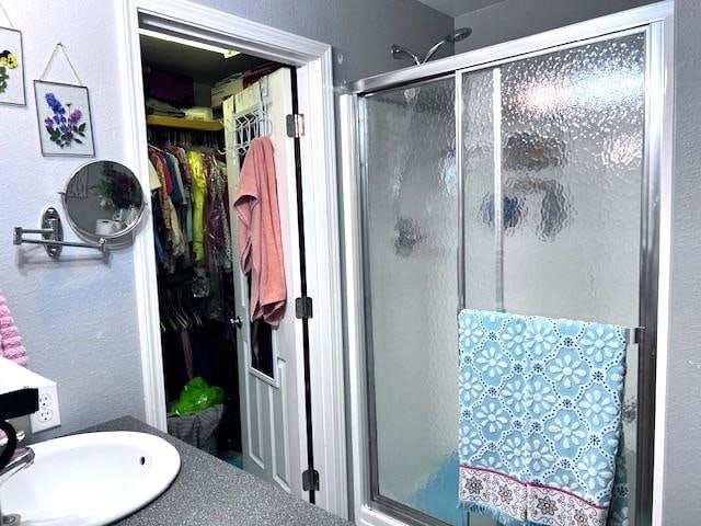 bathroom with sink and an enclosed shower