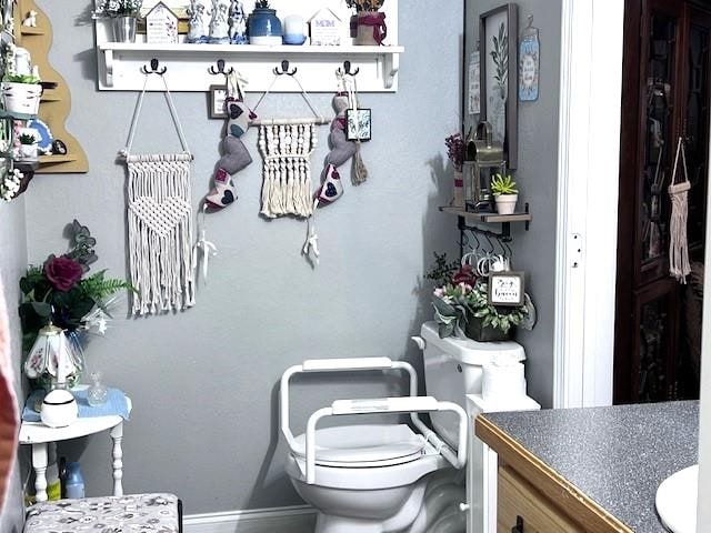 interior space featuring vanity and toilet