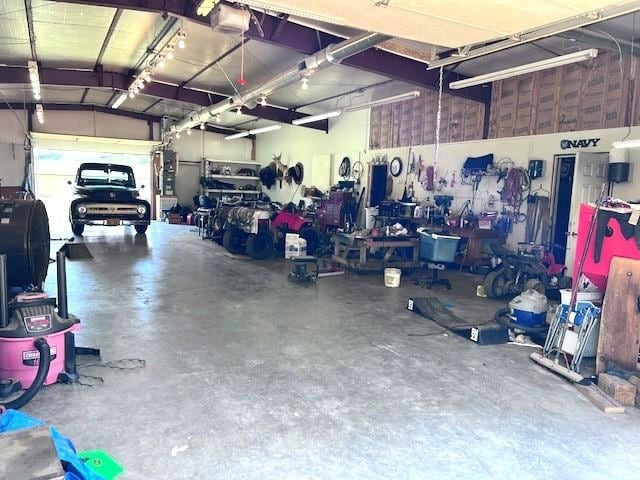 garage with a garage door opener and a workshop area