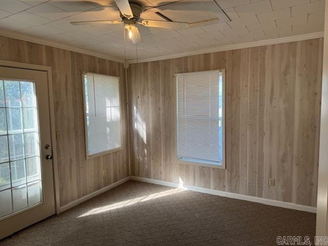 1912 Old County Rd, Pocahontas, AR 72455 - carpeted spare room featuring baseboards, crown molding, wood walls, and ceiling fan