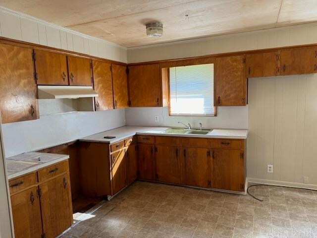 kitchen with wooden walls and sink