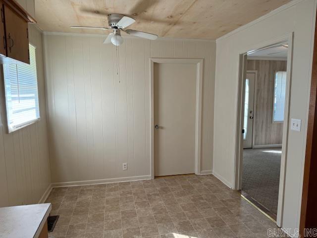 1912 Old County Rd, Pocahontas, AR 72455 - spare room featuring ceiling fan, wooden walls, and ornamental molding