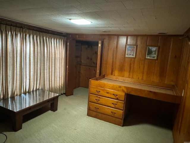 carpeted bedroom with wooden walls