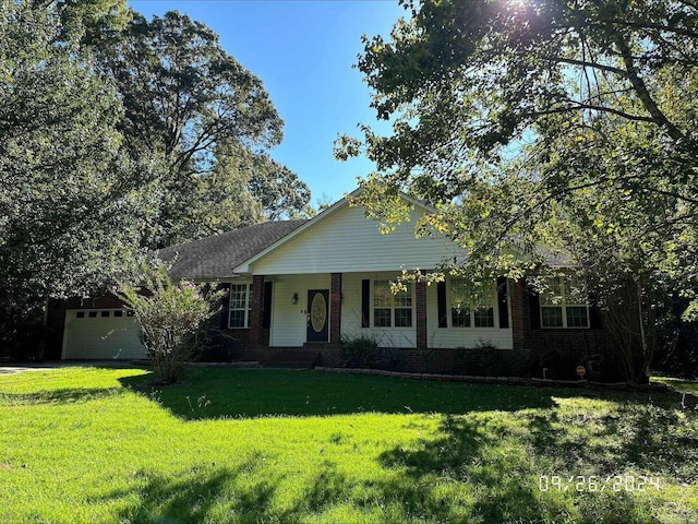 single story home with a garage and a front lawn