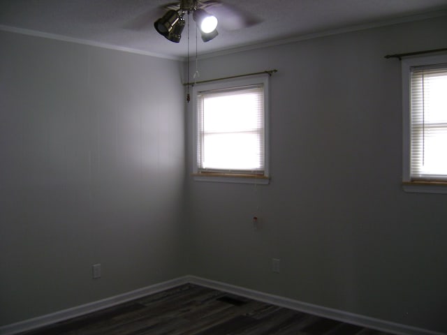 unfurnished room featuring ceiling fan, dark hardwood / wood-style floors, and crown molding