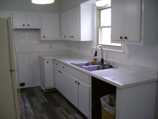 kitchen with white cabinetry, sink, dark wood-type flooring, and white fridge