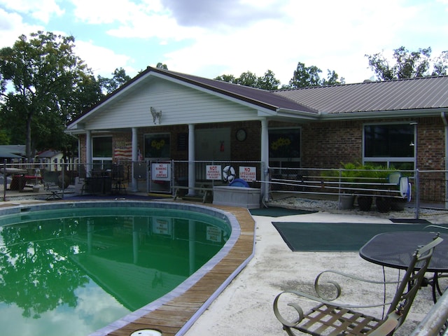 view of swimming pool featuring a patio