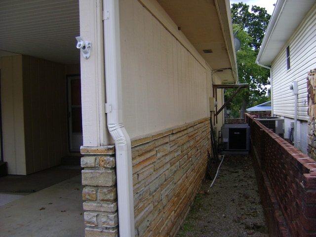 view of side of home featuring central AC