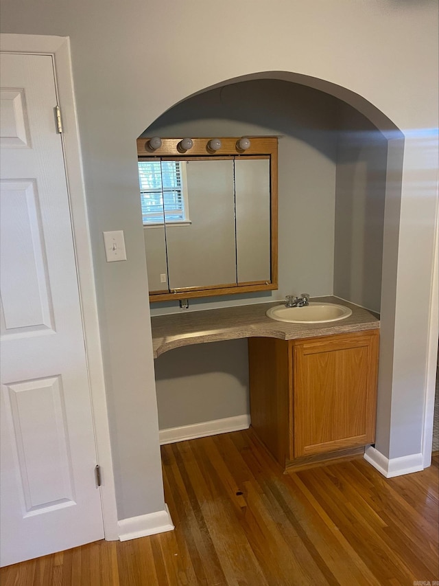 hallway with dark wood-type flooring and sink