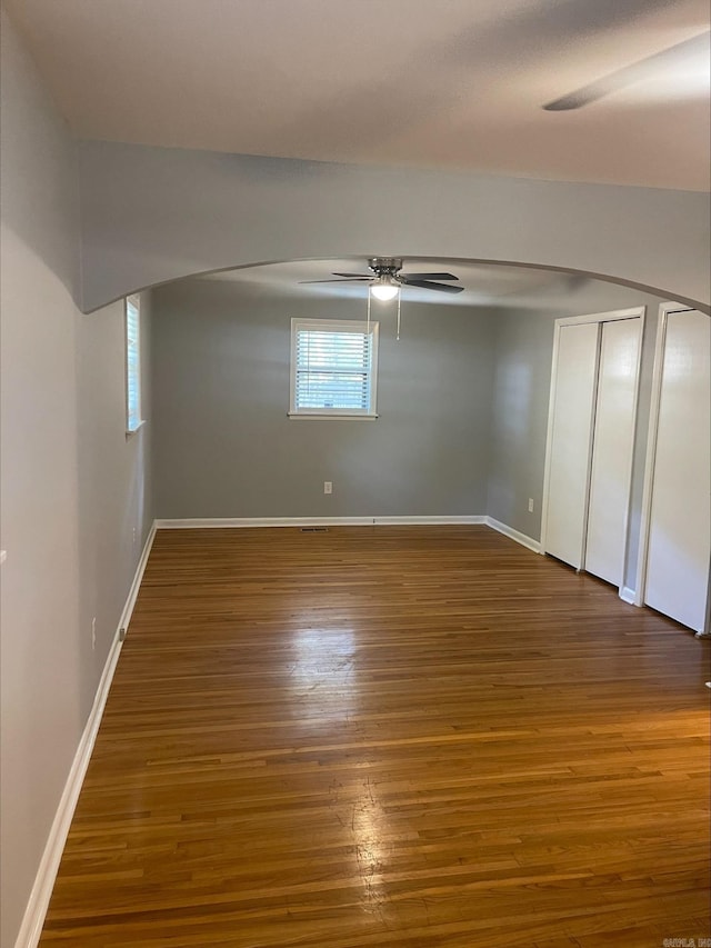 interior space with ceiling fan and dark hardwood / wood-style flooring