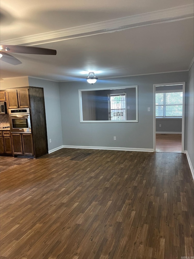 unfurnished living room featuring ceiling fan, dark hardwood / wood-style floors, and ornamental molding