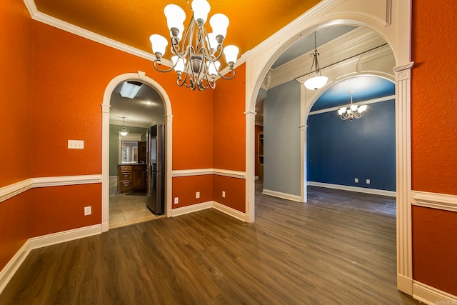 unfurnished room featuring a notable chandelier, crown molding, and dark wood-type flooring