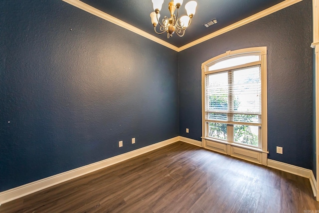 empty room featuring an inviting chandelier, crown molding, and dark wood-type flooring