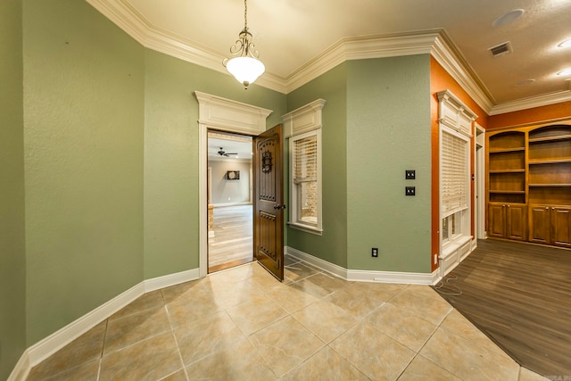 interior space with light hardwood / wood-style flooring, ceiling fan, and ornamental molding