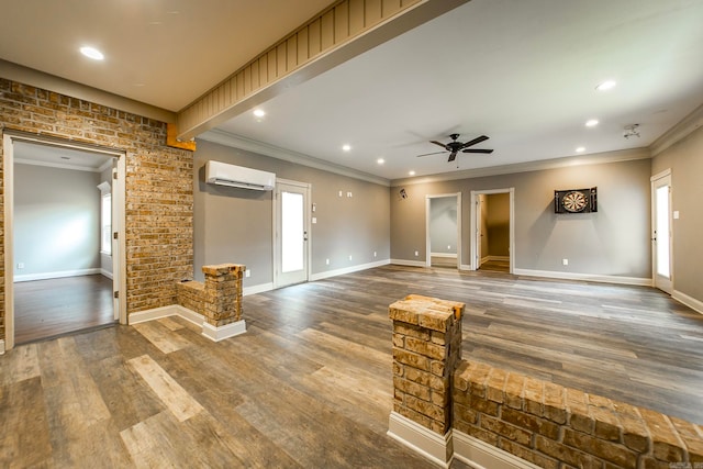 interior space with ceiling fan, ornamental molding, hardwood / wood-style floors, and a wall unit AC