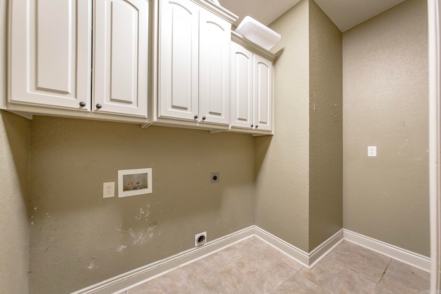 laundry area featuring cabinets, electric dryer hookup, hookup for a washing machine, and light tile patterned floors