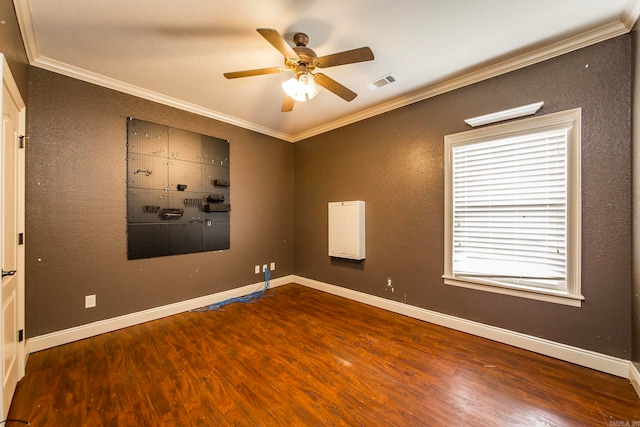 empty room featuring ornamental molding, ceiling fan, and hardwood / wood-style flooring