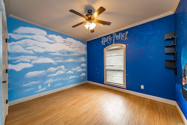 spare room with wood-type flooring, ornamental molding, and ceiling fan