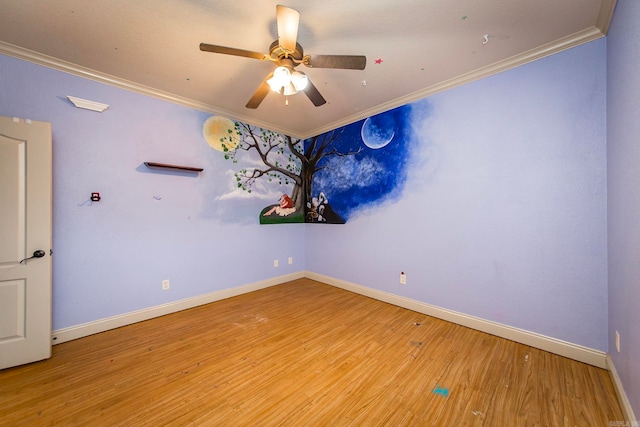 spare room featuring ceiling fan, light wood-type flooring, and crown molding