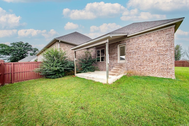 rear view of property with a lawn and a patio area