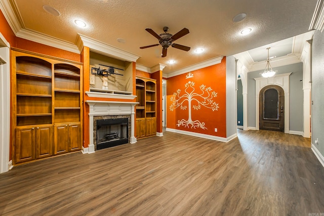 unfurnished living room with ceiling fan, a textured ceiling, crown molding, and dark hardwood / wood-style flooring