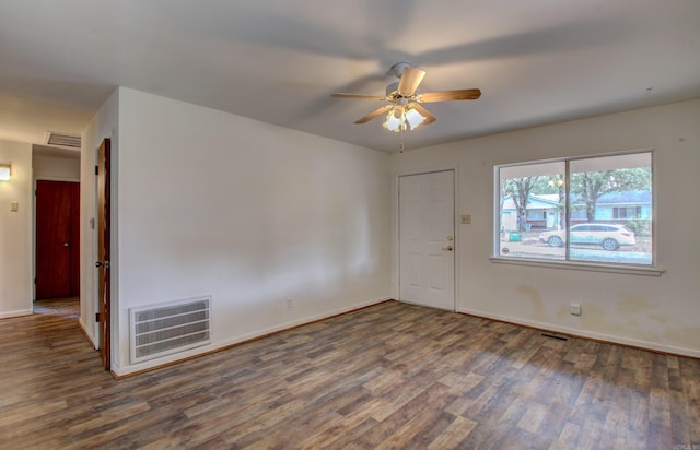 spare room with ceiling fan and dark hardwood / wood-style floors