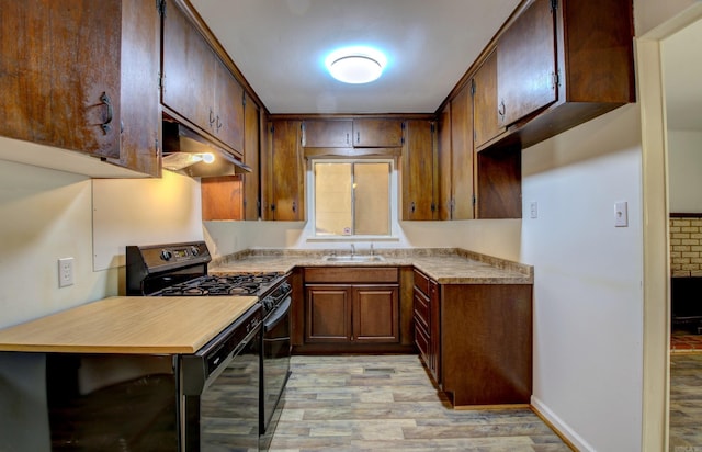 kitchen featuring light hardwood / wood-style flooring, black stove, and sink