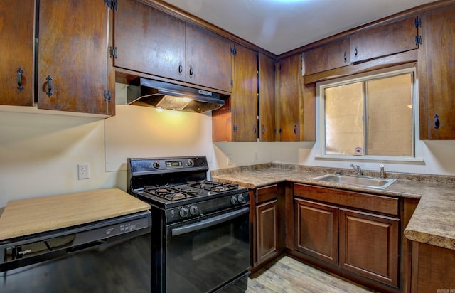 kitchen with light hardwood / wood-style flooring, sink, and black appliances