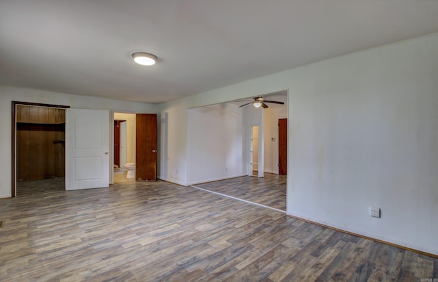 unfurnished room with ceiling fan and hardwood / wood-style flooring