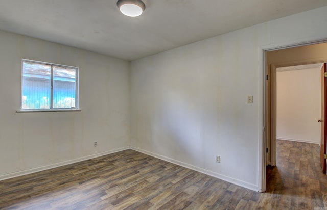 spare room with dark hardwood / wood-style flooring