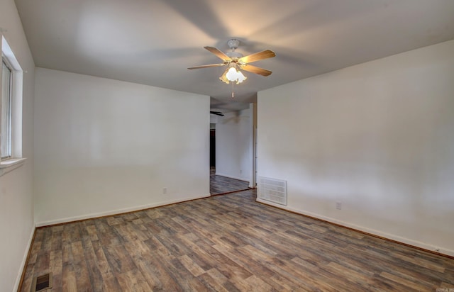 unfurnished room with dark hardwood / wood-style floors and ceiling fan