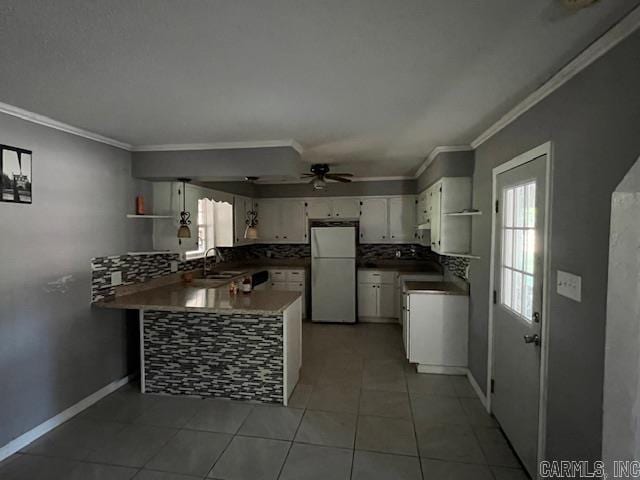 kitchen featuring ceiling fan, kitchen peninsula, white appliances, white cabinetry, and tile patterned flooring