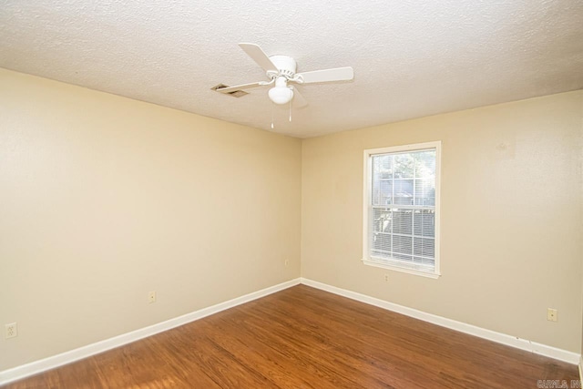 spare room featuring ceiling fan, hardwood / wood-style flooring, and a textured ceiling