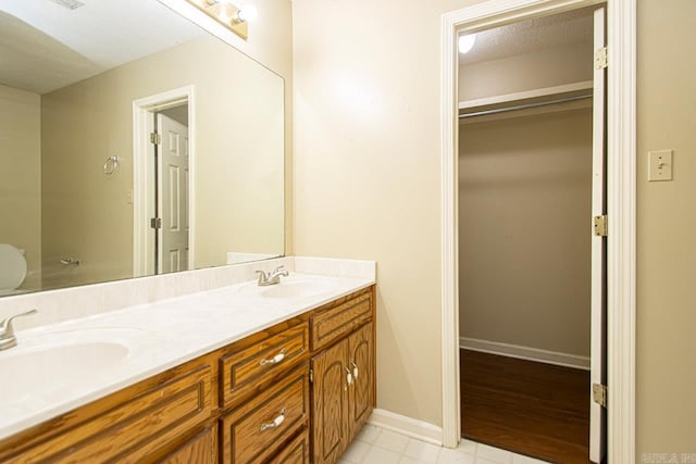 bathroom featuring wood-type flooring, a textured ceiling, and vanity