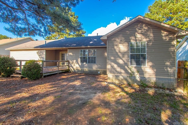 rear view of property with a wooden deck