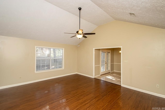 interior space with a textured ceiling, lofted ceiling, hardwood / wood-style floors, and ceiling fan