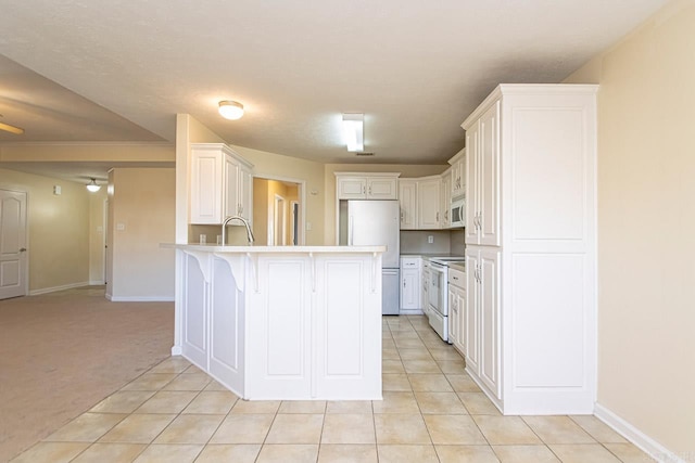 kitchen featuring white cabinetry, white appliances, a kitchen bar, ceiling fan, and light colored carpet