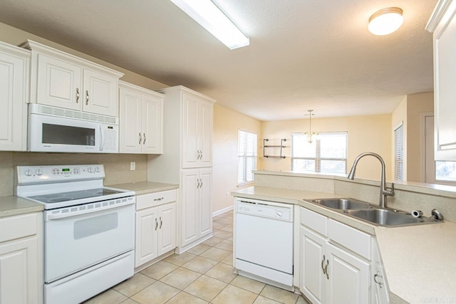 kitchen with sink, white appliances, and white cabinetry