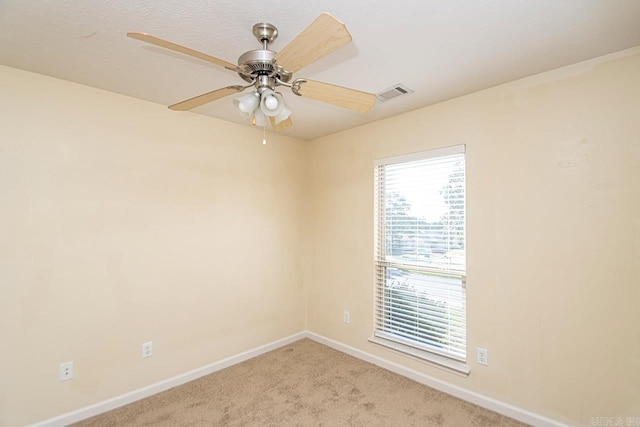 carpeted spare room with ceiling fan